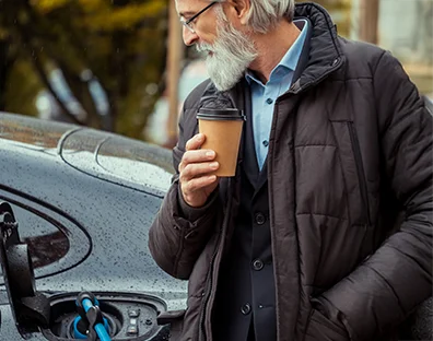 Man with coffee and electric vehicle